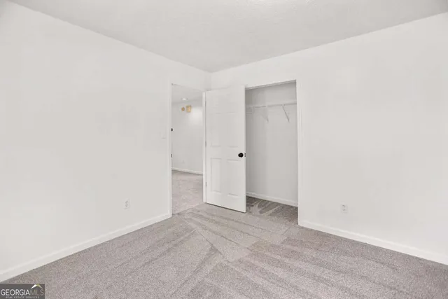 wooden floor in an empty room with a ceiling fan
