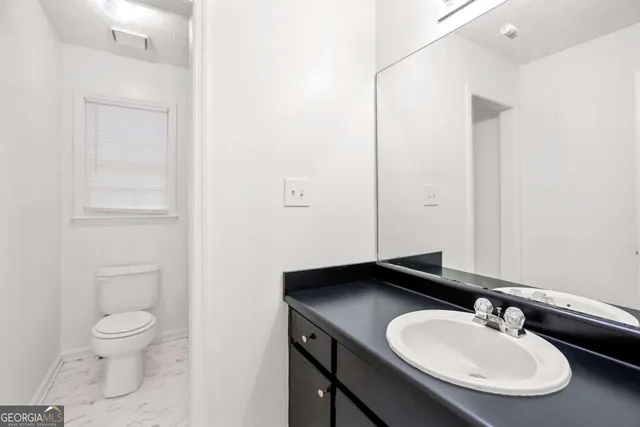 a bathroom with a sink a bathtub and a mirror