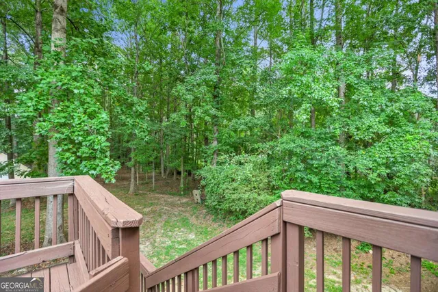 an aerial view of residential house with outdoor space and trees all around