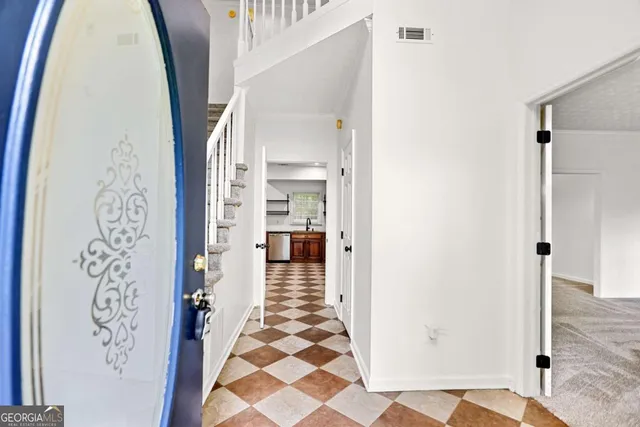 a view of staircase with wooden floor and a rug