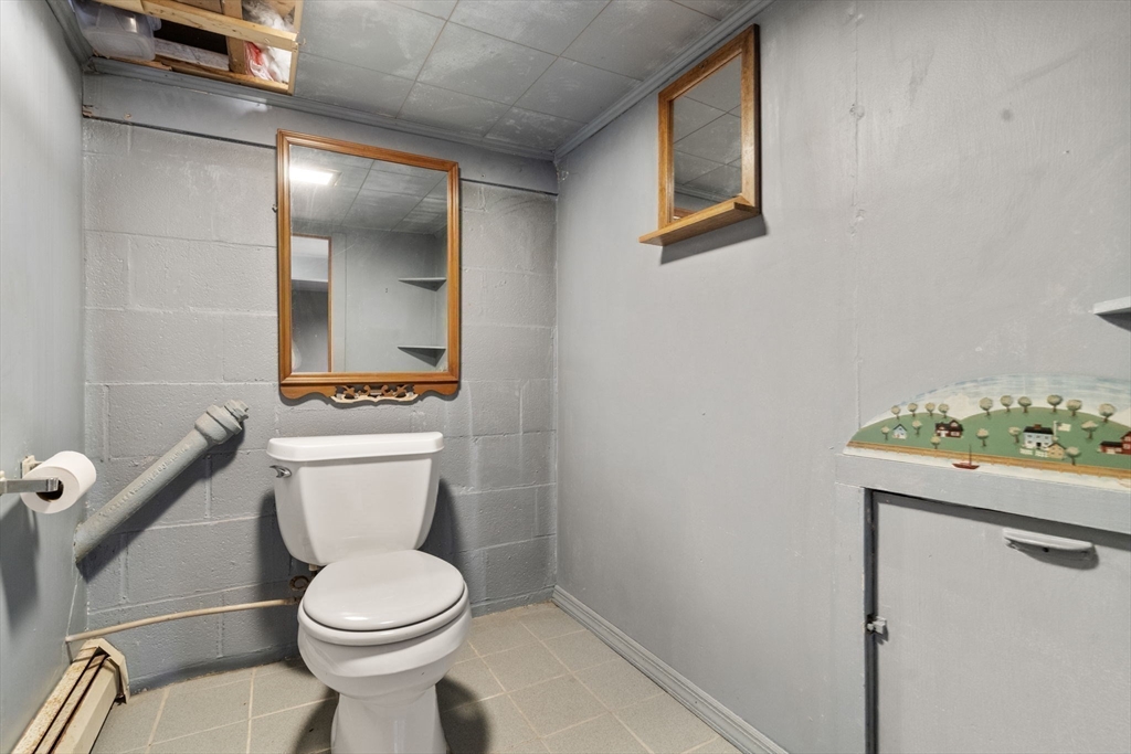 30 Wampum Avenue Waltham, MA 02451 - Photo 16 of 29 a white toilet sitting next to a bathroom sink