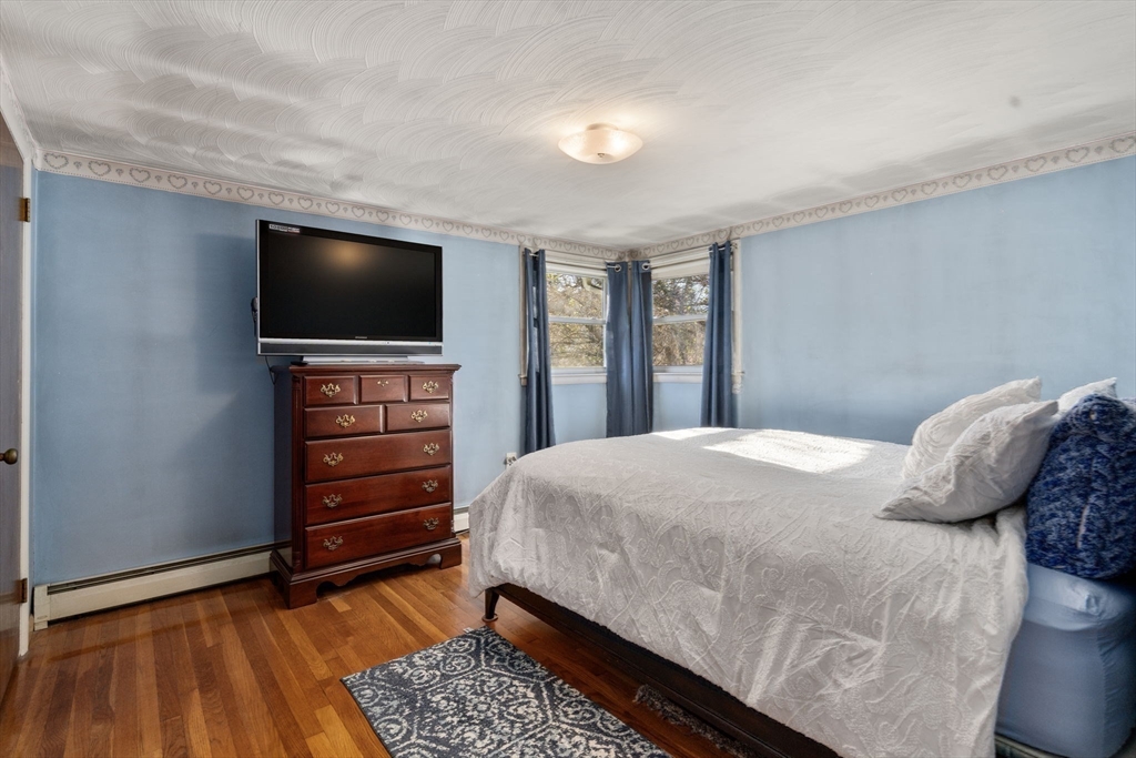 30 Wampum Avenue Waltham, MA 02451 - Photo 18 of 29 a bedroom with a bed and a flat screen tv