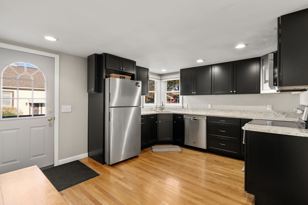 30 Wampum Avenue Waltham, MA 02451 - Photo 7 of 29 a kitchen with a refrigerator and a sink