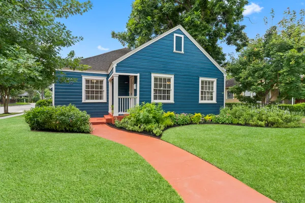a view of a house with yard and green space