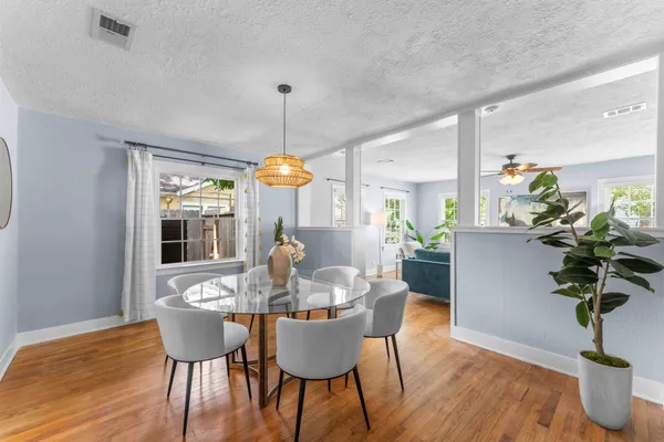 a view of a dining room with furniture window and wooden floor