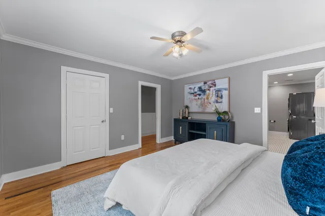 a bedroom with a bed and a chandelier