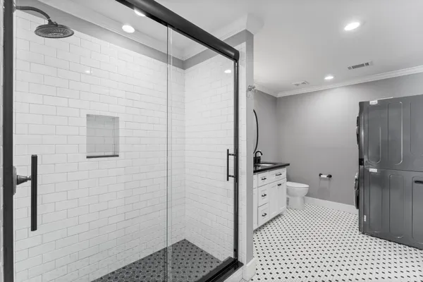 a bathroom with a sink a toilet and shower