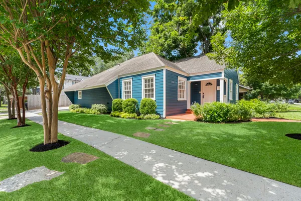 a front view of house with yard and green space