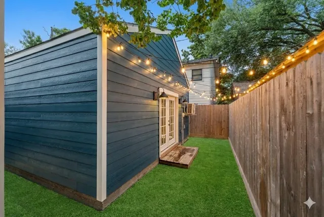 a view of a backyard with wooden fence