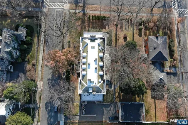 a backyard of a building with lots of trees
