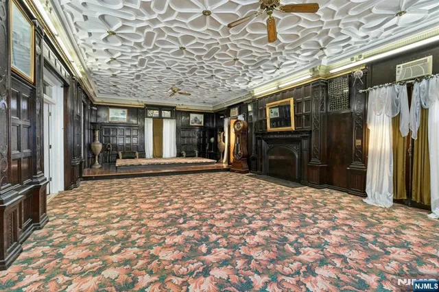 a living room with furniture a fireplace and wooden floor