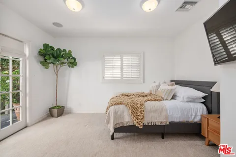 a bedroom with bed and a couch