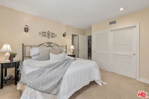 a bedroom with a bed and a night stand