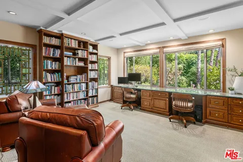 a living room with furniture and a book shelf