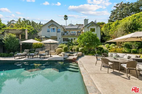 a view of a house with swimming pool and sitting area