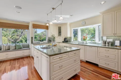 a kitchen with a stove and a large window