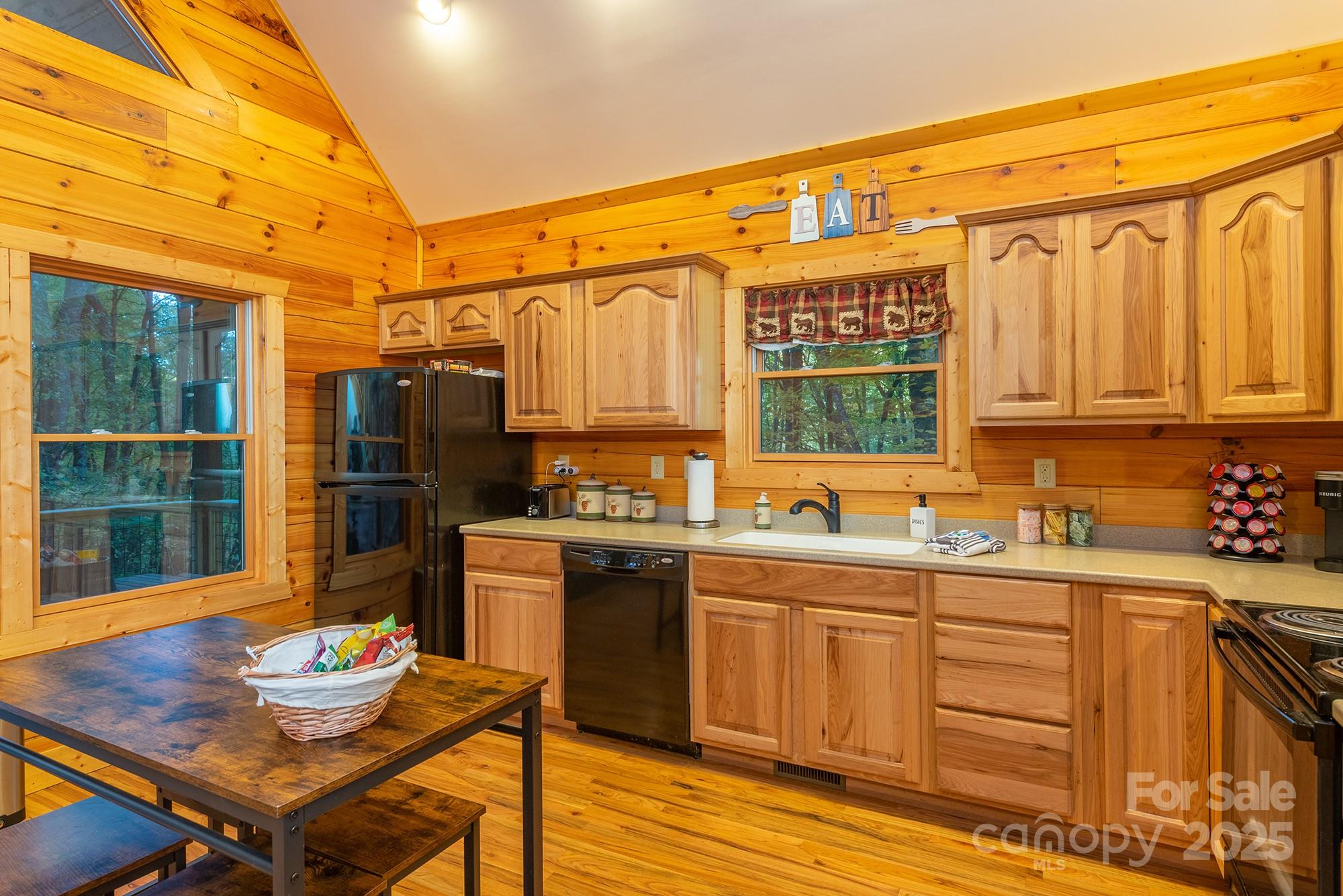 100 Candlemaker Trail Maggie Valley, NC 28751 - Photo 12 of 34 a kitchen with stainless steel appliances granite countertop a sink a stove and refrigerator