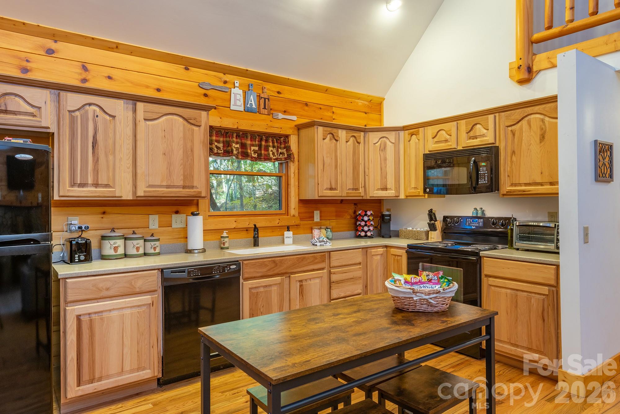 100 Candlemaker Trail Maggie Valley, NC 28751 - Photo 12 of 34 a kitchen with a sink a stove and chairs