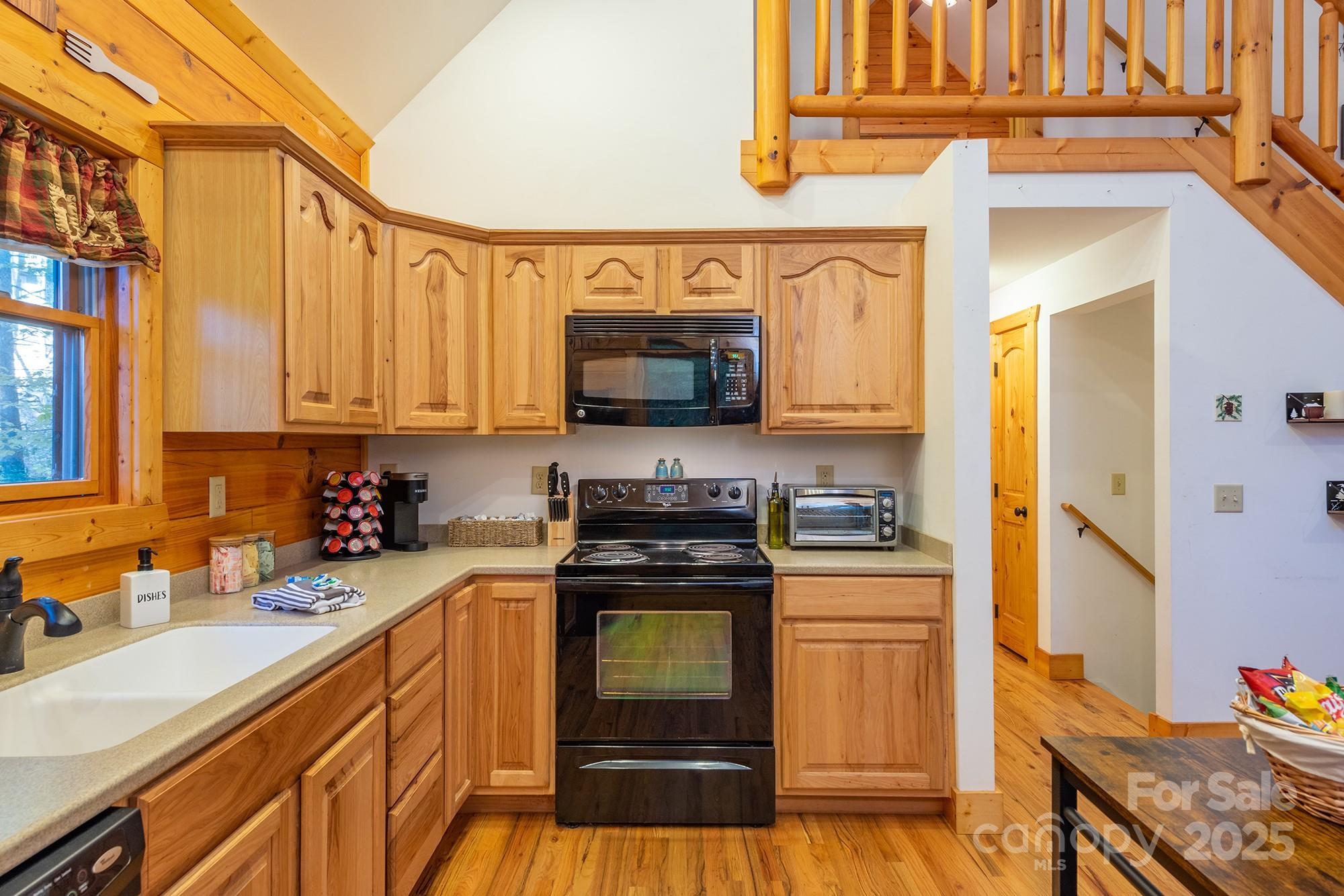 100 Candlemaker Trail Maggie Valley, NC 28751 - Photo 13 of 34 a kitchen with stainless steel appliances granite countertop a stove and a sink