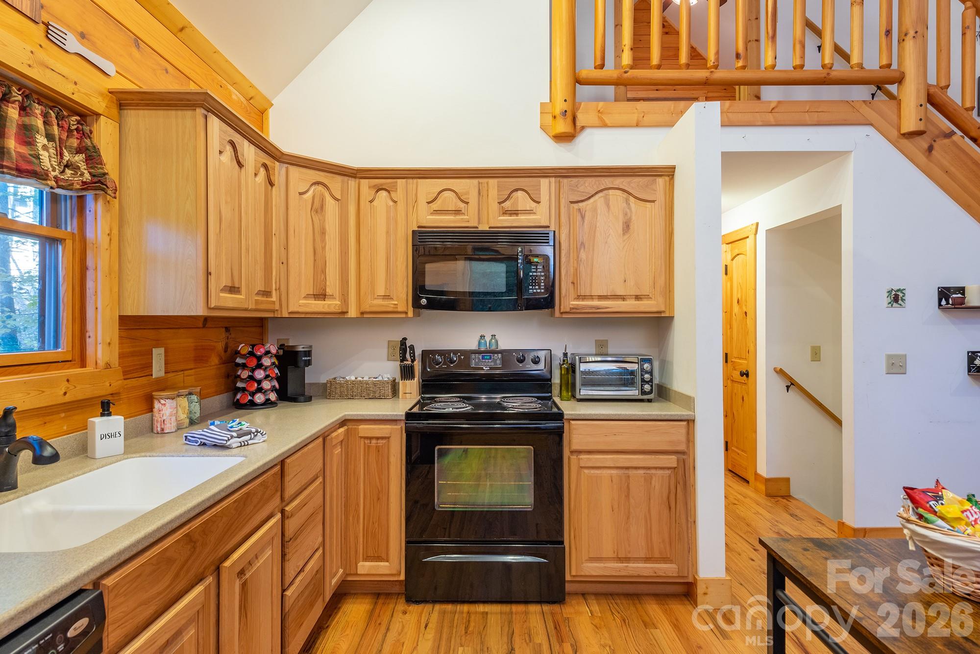 100 Candlemaker Trail Maggie Valley, NC 28751 - Photo 14 of 34 a kitchen with stainless steel appliances granite countertop a stove and a sink