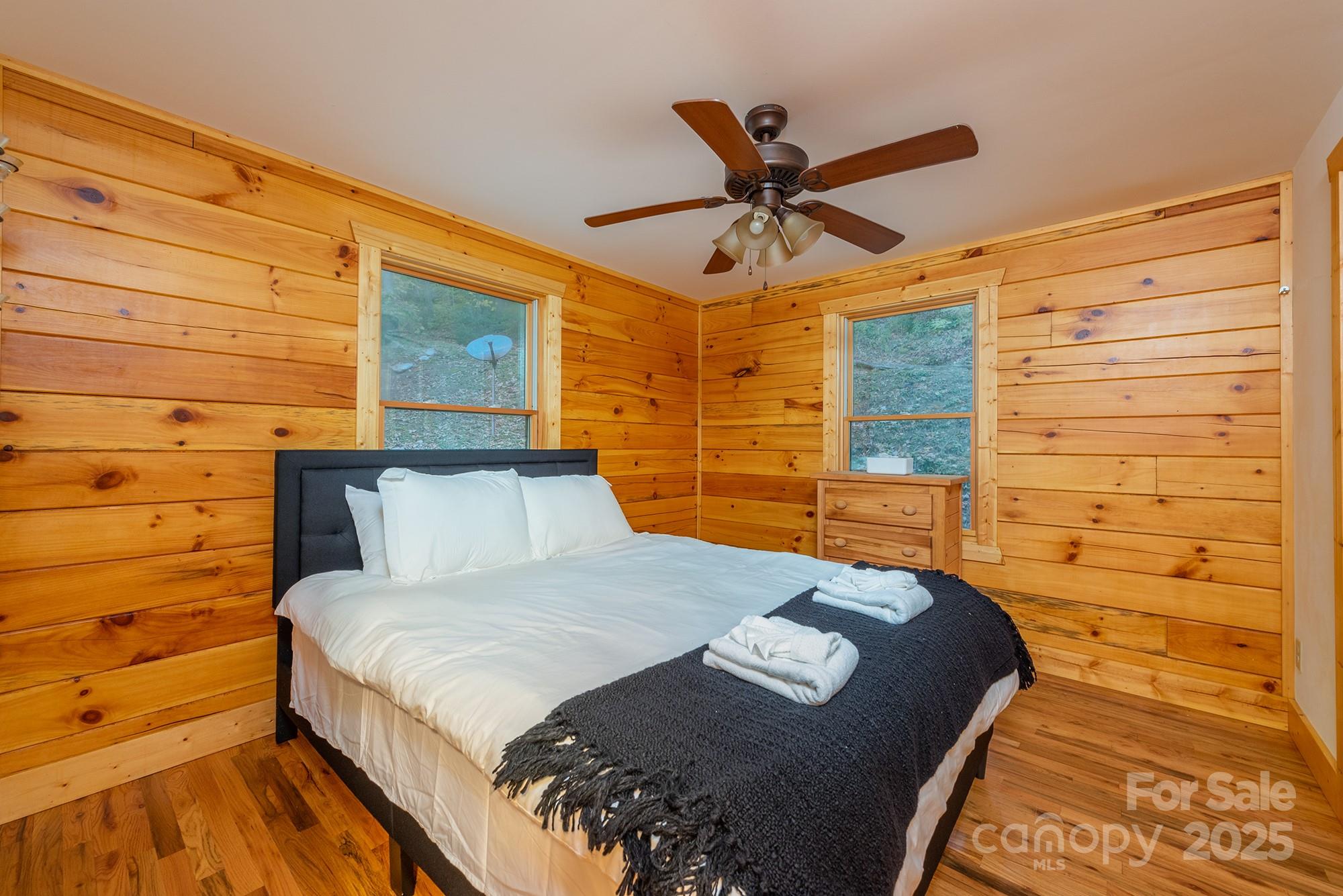 100 Candlemaker Trail Maggie Valley, NC 28751 - Photo 14 of 34 a bedroom with a bed and a walk in closet
