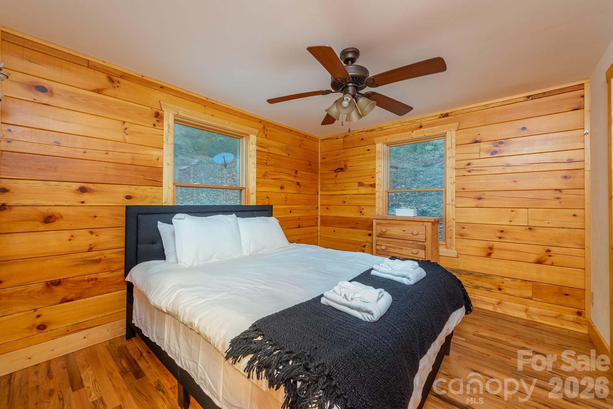 100 Candlemaker Trail Maggie Valley, NC 28751 - Photo 15 of 34 a bedroom with a bed and a walk in closet