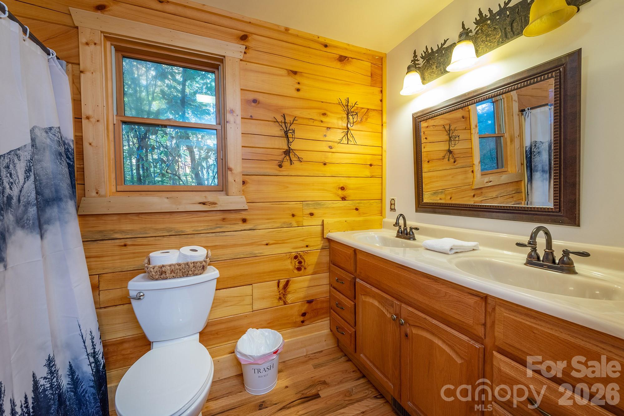100 Candlemaker Trail Maggie Valley, NC 28751 - Photo 17 of 34 a bathroom with a granite countertop toilet sink and mirror