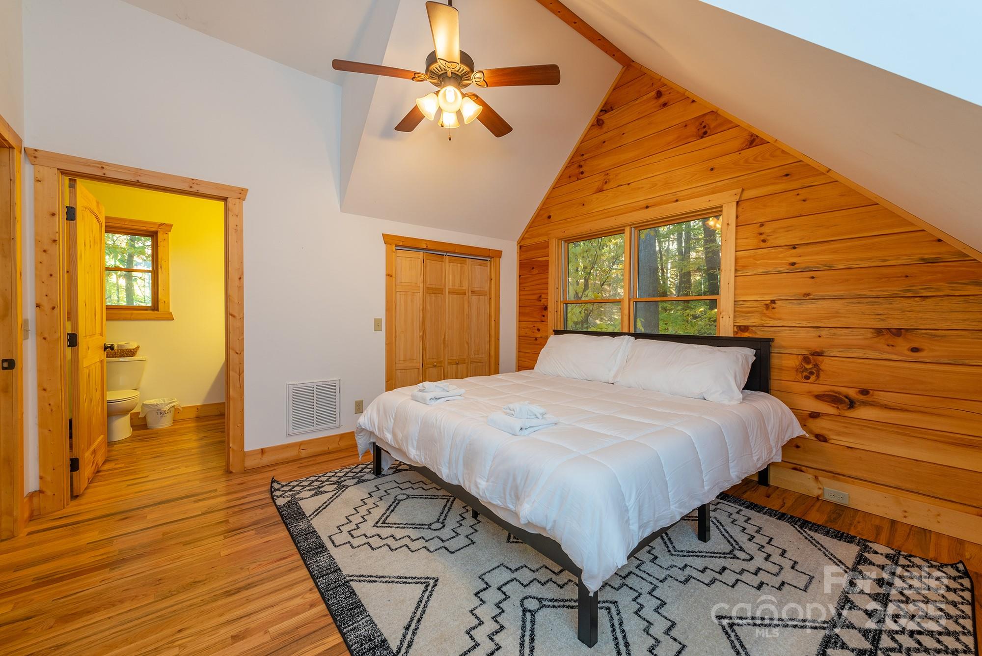 100 Candlemaker Trail Maggie Valley, NC 28751 - Photo 18 of 34 a bedroom with a bed and wooden floor