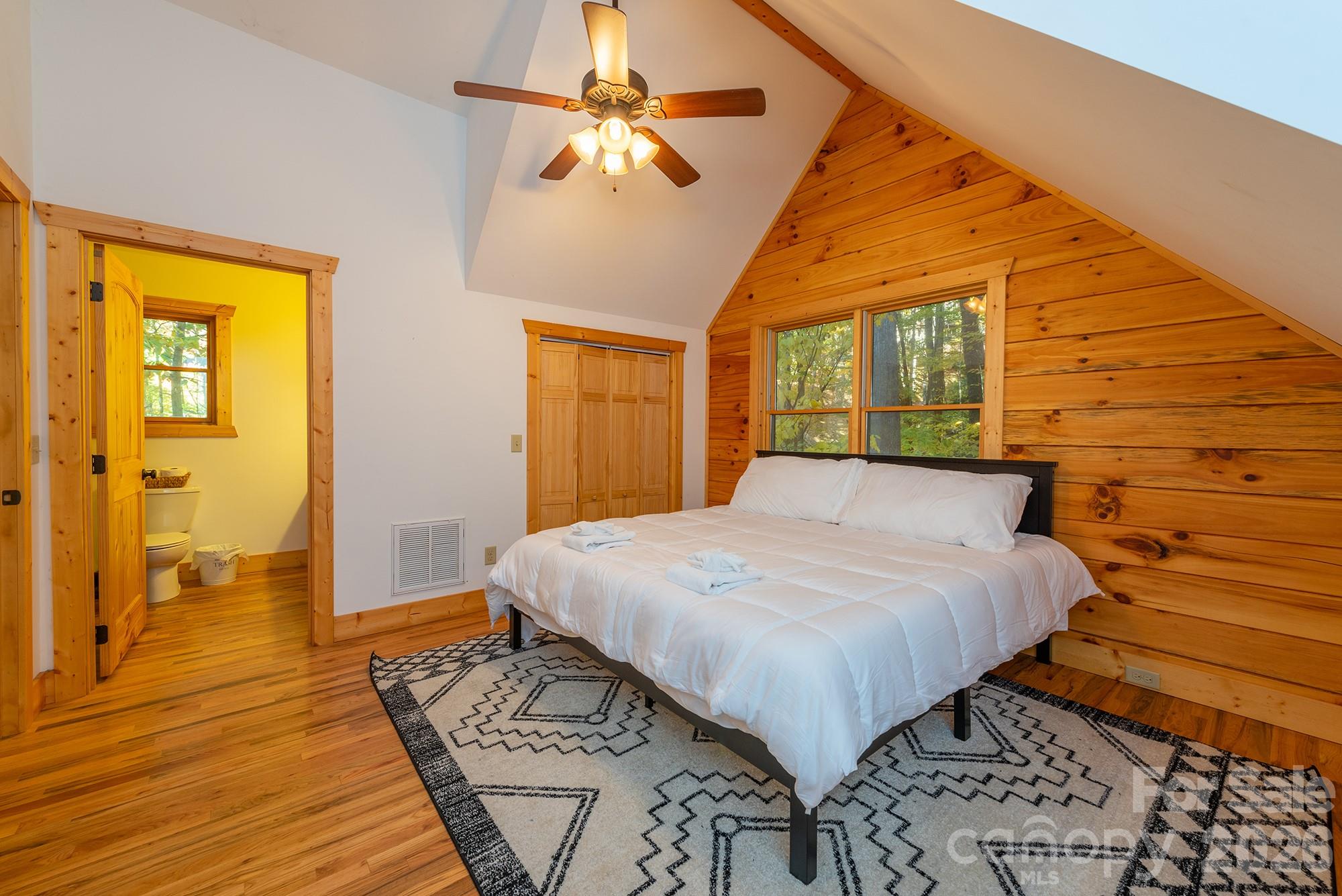 100 Candlemaker Trail Maggie Valley, NC 28751 - Photo 19 of 34 a bedroom with a bed and wooden floor