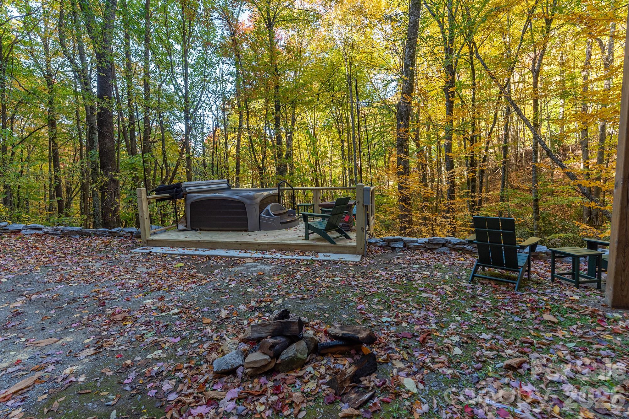 100 Candlemaker Trail Maggie Valley, NC 28751 - Photo 24 of 34 a view of a backyard with table and chairs
