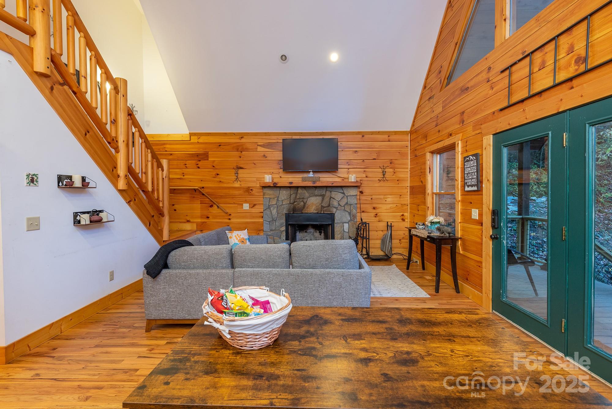100 Candlemaker Trail Maggie Valley, NC 28751 - Photo 7 of 34 a living room with fireplace furniture and a wooden floor