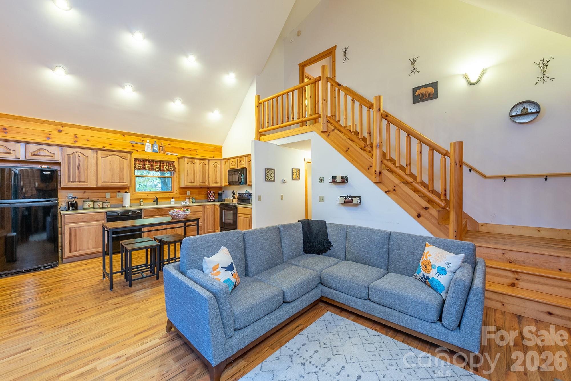 100 Candlemaker Trail Maggie Valley, NC 28751 - Photo 10 of 34 a living room with fireplace furniture and a wooden floor