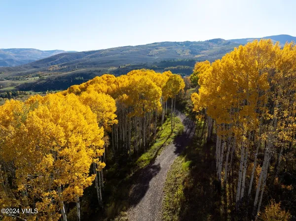 a view of a lush green hillside and a building