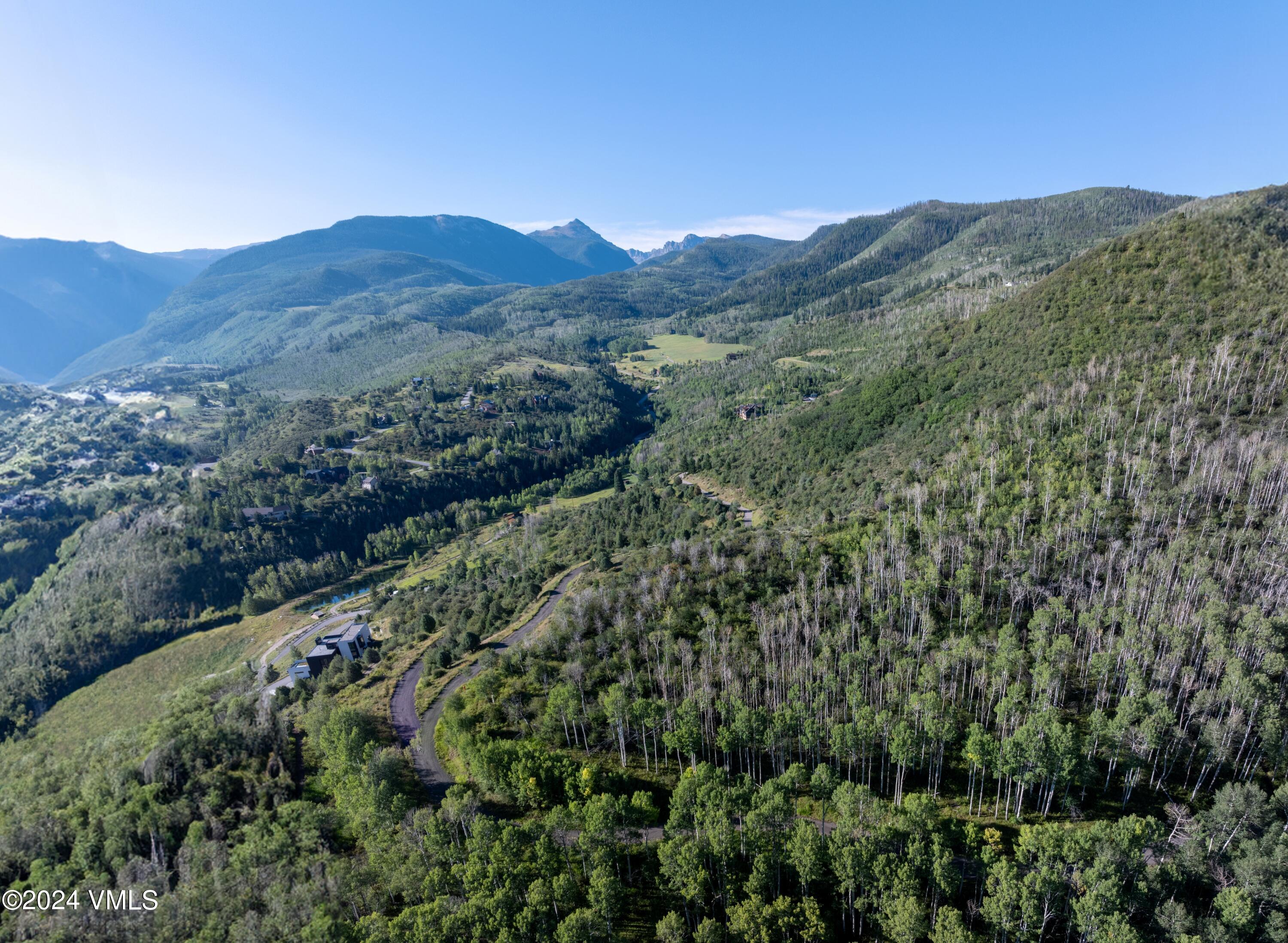 420 Saddle Horn Way Edwards, CO 81632 - Photo 7 of 13 a view of a lush green hillside and a building