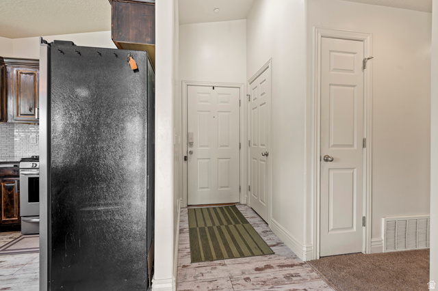 8248 South Resaca Drive, Unit J10 Sandy, UT 84070 - Photo 11 of 40 Bright entryway featuring light wood-finish flooring and a neutral color palette