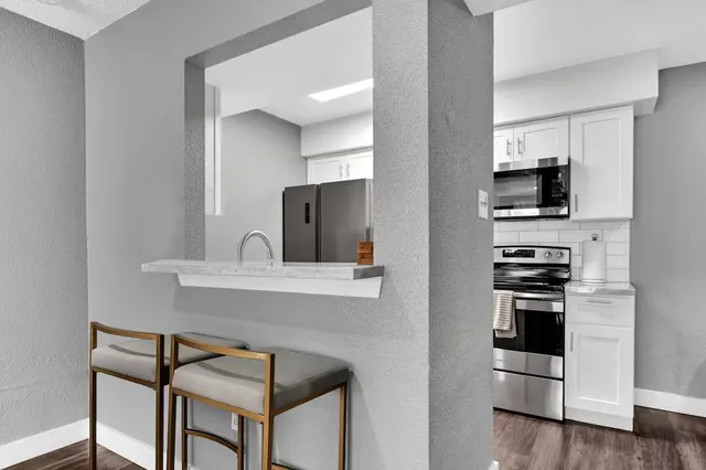 a kitchen with a stove and a refrigerator