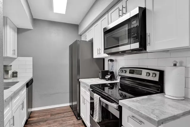 a kitchen with a stove and a microwave