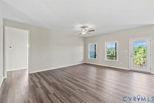 a view of a kitchen with a wooden floor and a kitchen island