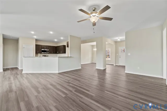 a view of kitchen with cabinets microwave and stove