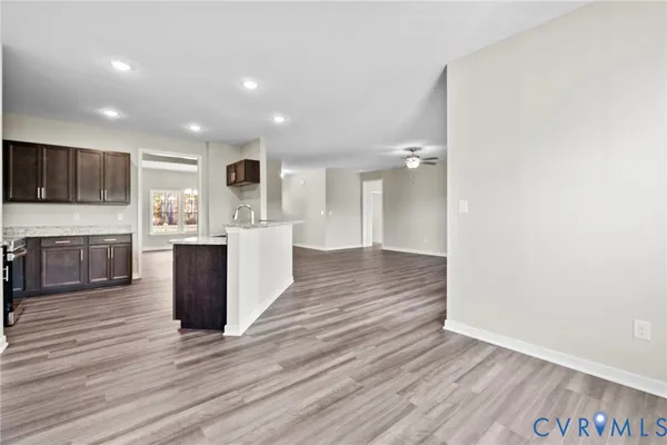 a kitchen with stainless steel appliances kitchen island granite countertop a stove a sink and a microwave