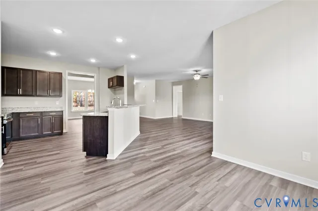 a kitchen with granite countertop a stove top oven sink and cabinets