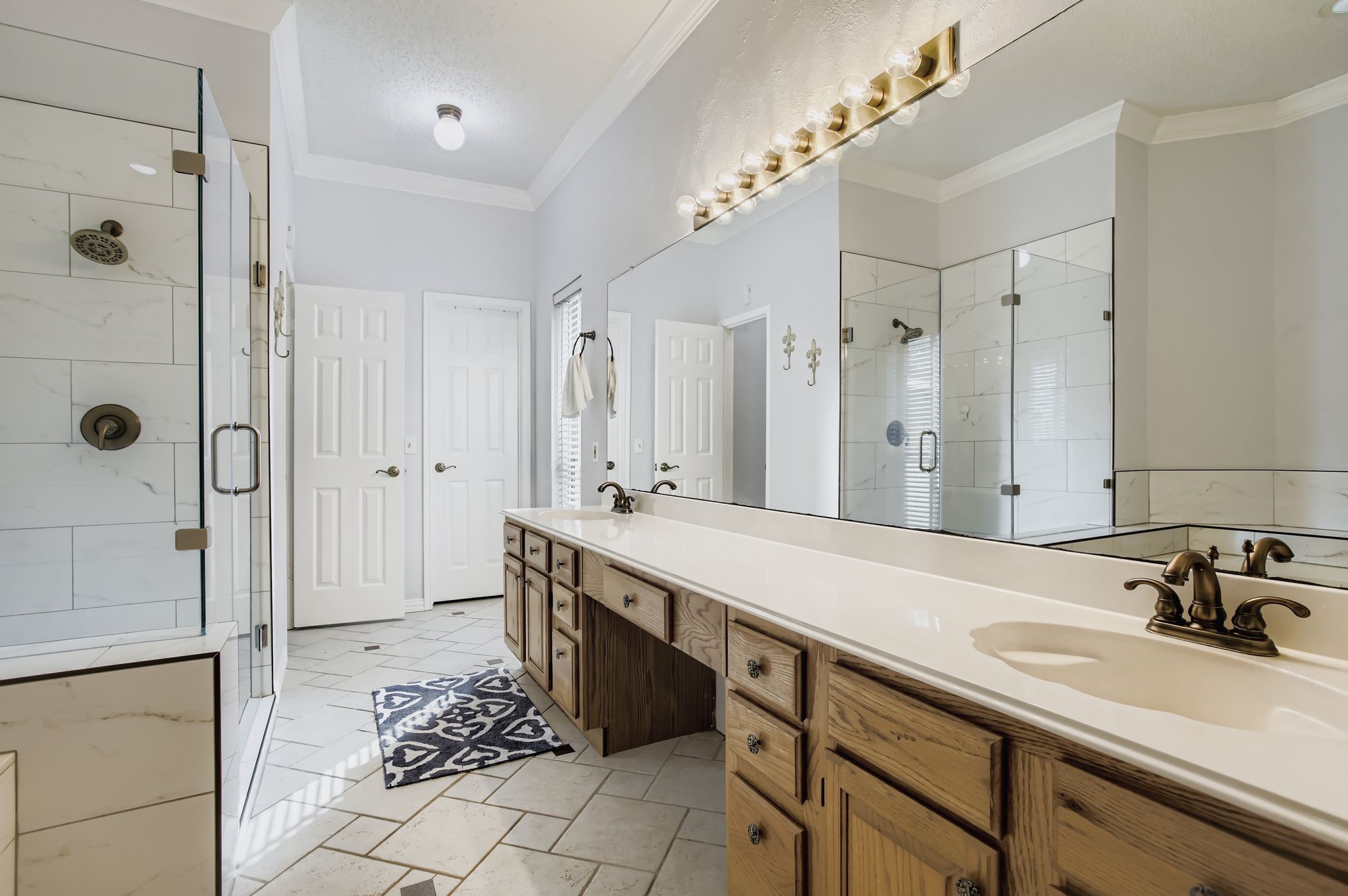 7530 Dogwood Falls Road Houston, TX 77095 - Photo 19 of 27 The primary bathroom has tile flooring, dual sinks and a vanity area.