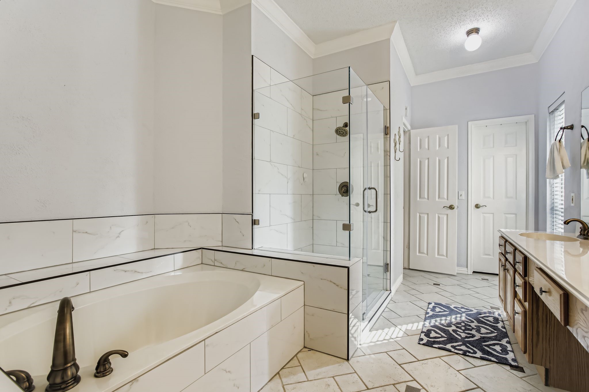 7530 Dogwood Falls Road Houston, TX 77095 - Photo 20 of 27 The primary bathroom offers a recently updated shower and soaking tub.