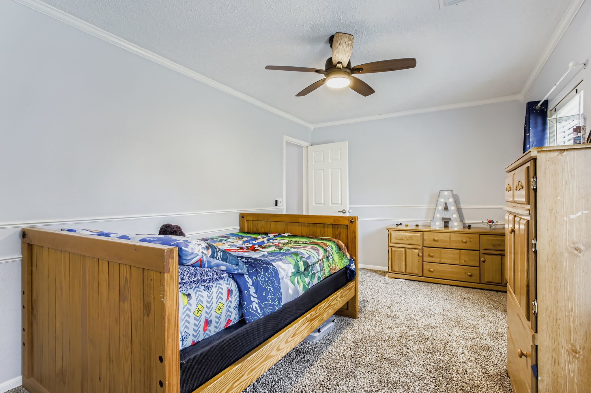 7530 Dogwood Falls Road Houston, TX 77095 - Photo 23 of 27 Secondary bedroom #3 offers a modern remote control ceiling fan, and two double door closets.