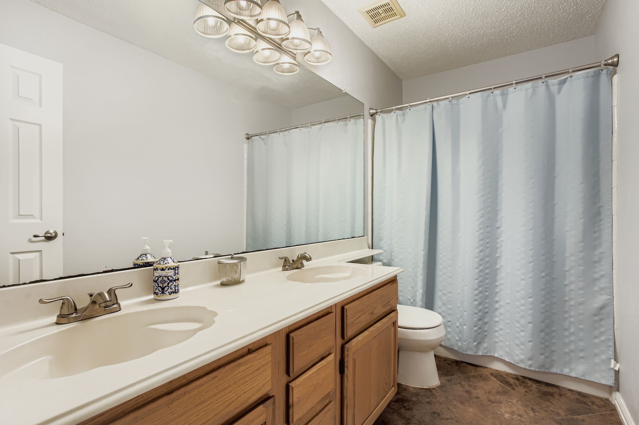 7530 Dogwood Falls Road Houston, TX 77095 - Photo 24 of 27 The spacious upstars hallway bath offers dual sinks and plenty of counter space.