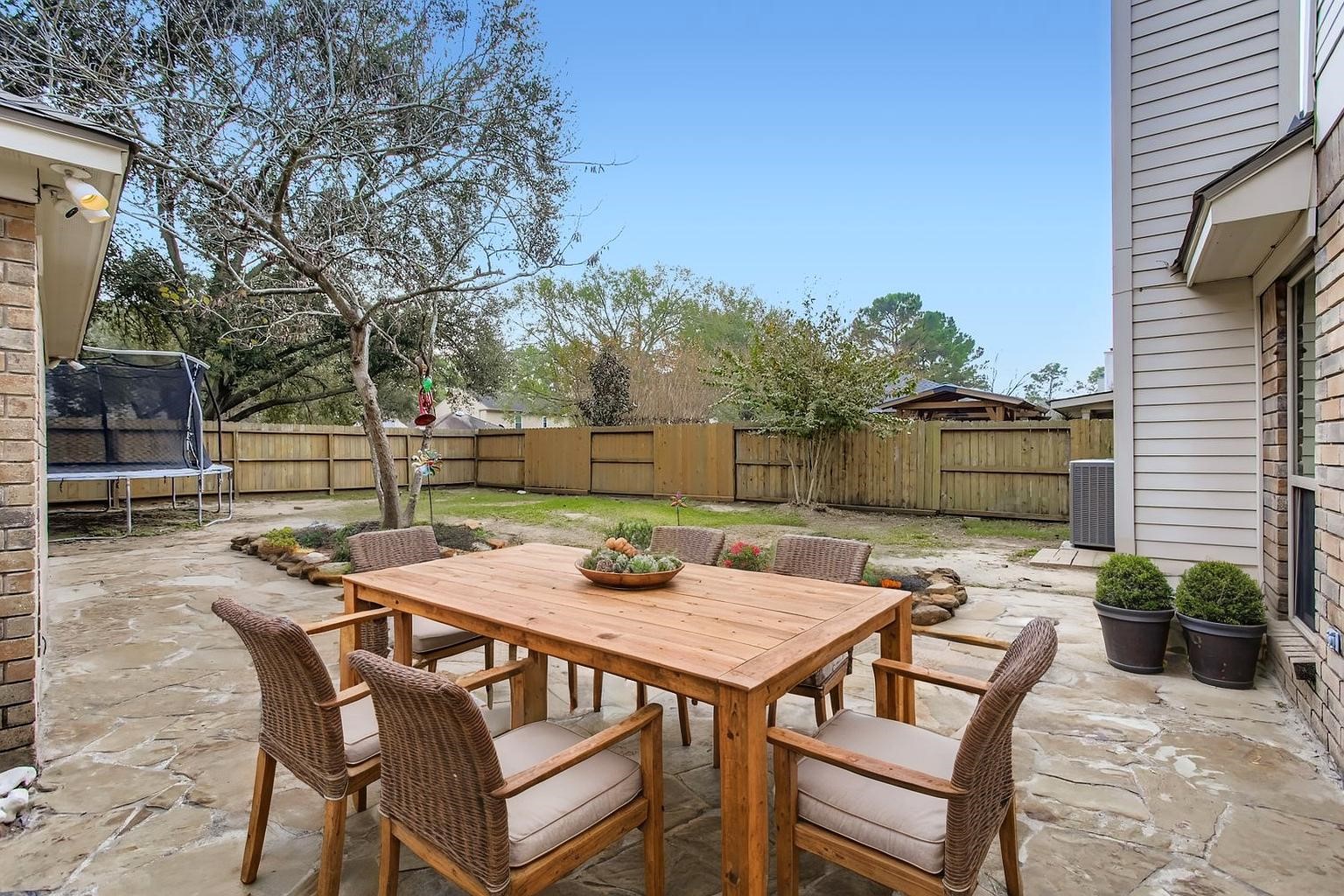 7530 Dogwood Falls Road Houston, TX 77095 - Photo 26 of 27 Out back, a massive flagstone patio, new fence and large back yard. (photo is virtually staged to show the potential of the space)