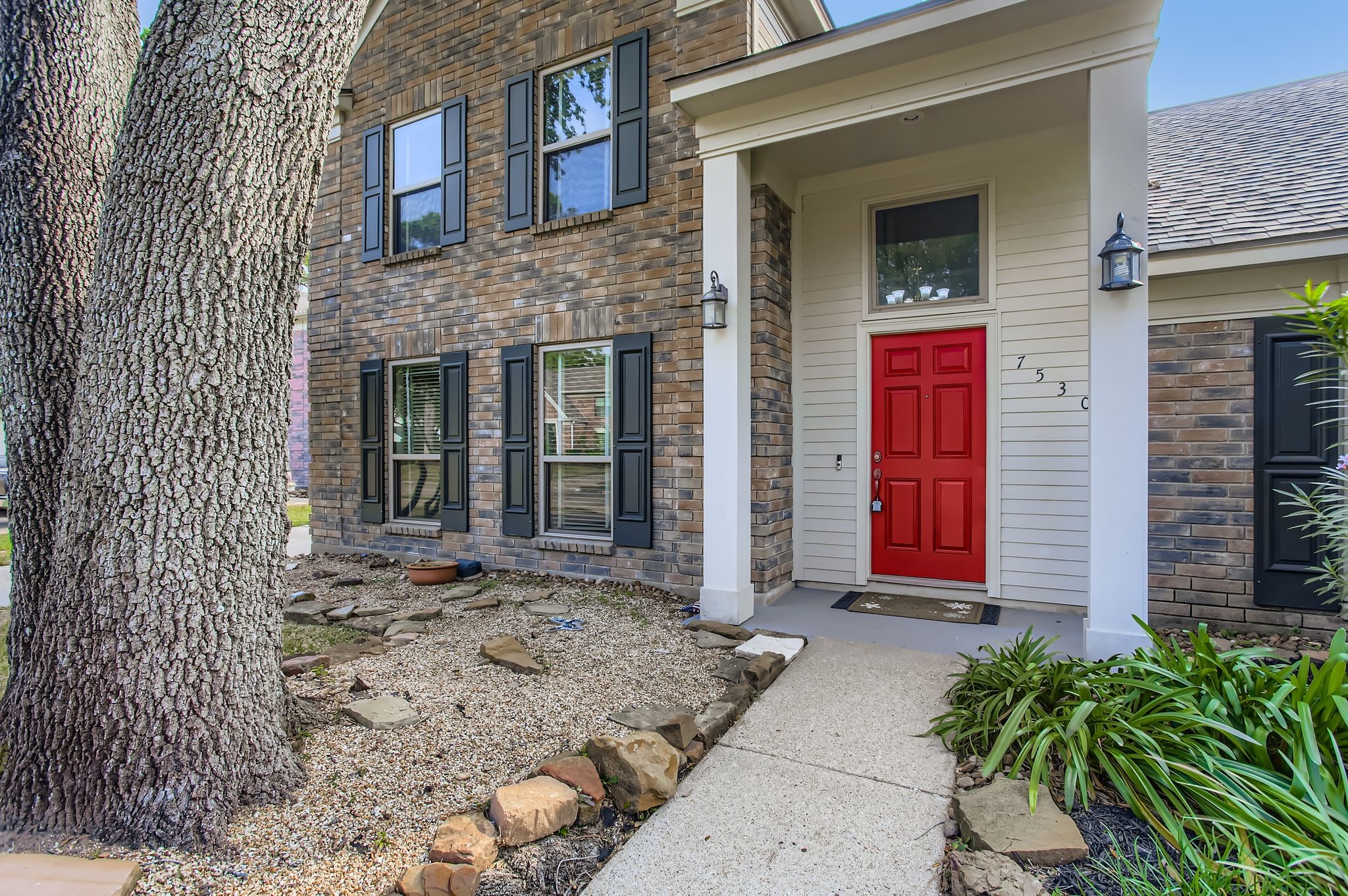 7530 Dogwood Falls Road Houston, TX 77095 - Photo 4 of 27 You are greeted by mature trees, and a cozy covered front porch with coach lights on either side.