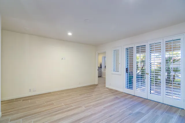 a room with pool table and windows