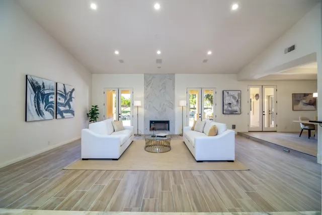 a view of a dining room with furniture wooden floor and chandelier