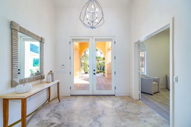 a view of a dining room with furniture and chandelier